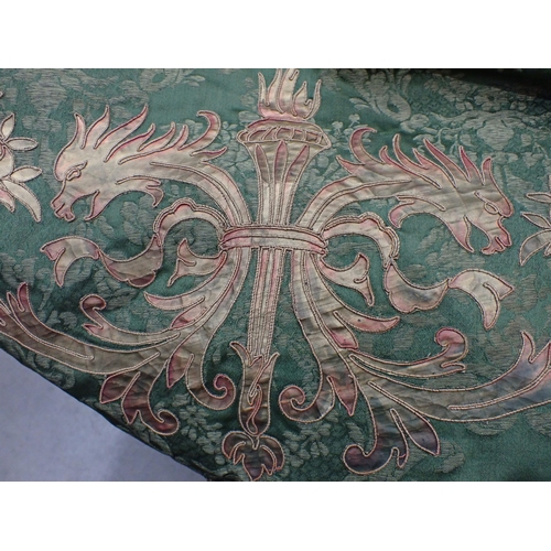 201 - A 19th Century green damask Wall Hanging with appliquéd heraldic crest within borders of scrolls, co... 