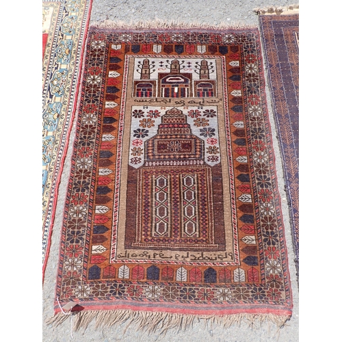 276 - A cream ground Prayer Rug with blue border 5ft L x 3ft W, another with temple design within red bord... 