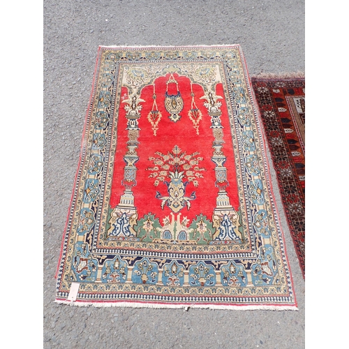 276 - A cream ground Prayer Rug with blue border 5ft L x 3ft W, another with temple design within red bord... 