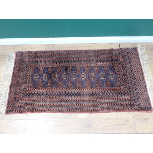 324 - A bordered Persian Rug with coloured medallions on a red ground, 5ft 11in x 3ft 3in, and a small Run... 