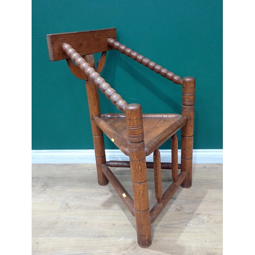 328 - An ash and oak Turned Chair in the 17th Century style with bobbin turned arms and ring turned suppor... 