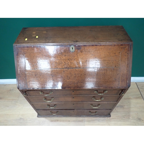 348 - A 19th Century oak bureau with sloping front enclosing a fitted interior above two short and three l... 