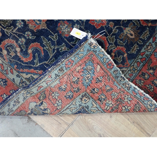 379A - A bordered Persian Rug with floral motifs on a blue ground, 6ft 6in x 4ft 5in