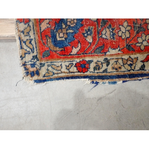 379A - A bordered Persian Rug with floral motifs on a blue ground, 6ft 6in x 4ft 5in