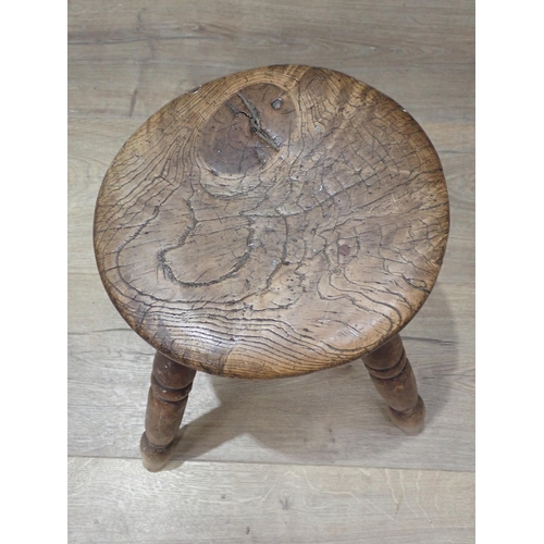 423 - An antique rustic elm Stool on four turned legs 11in H x 9 1/2in D