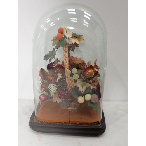 527 - An artificial display of flowers in a basket under glass dome, 15in H