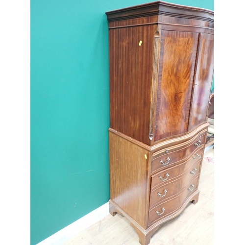 57 - A reproduction mahogany veneered Cupboard fitted pair of serpentine doors above single drawer and cu... 