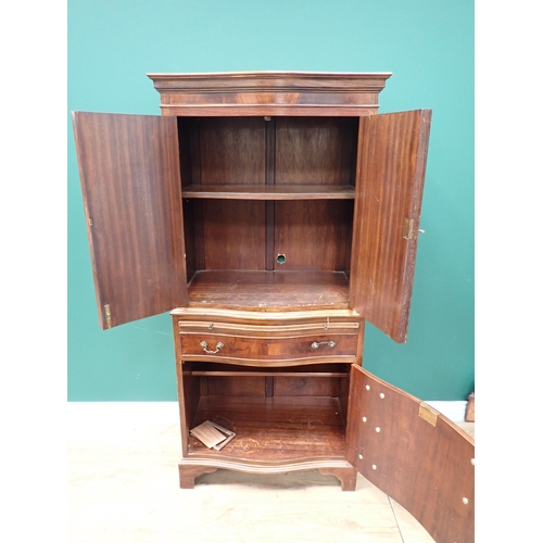 57 - A reproduction mahogany veneered Cupboard fitted pair of serpentine doors above single drawer and cu... 