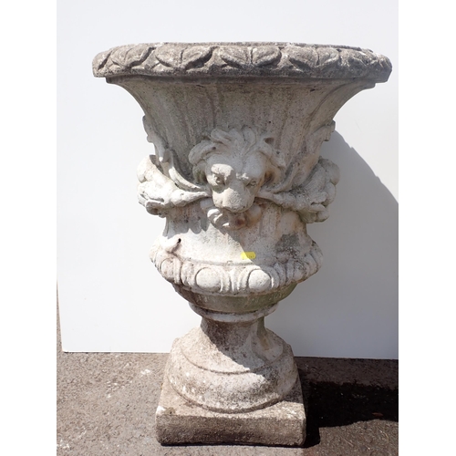 608 - A pair of concrete Garden Urns with moulded lion mask and swag design (both cracked) 2ft 4in H x 1ft... 