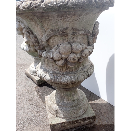 608 - A pair of concrete Garden Urns with moulded lion mask and swag design (both cracked) 2ft 4in H x 1ft... 