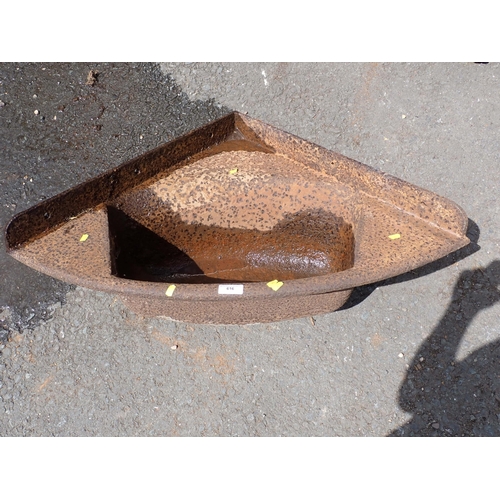 616 - An antique cast iron corner Trough