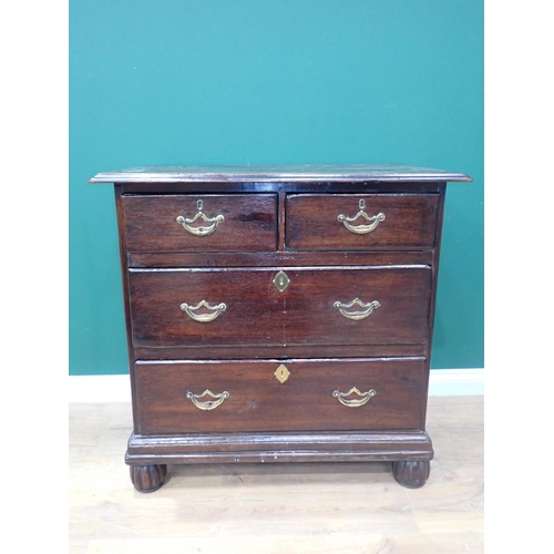 63 - An 18th Century oak Chest with moulded top above two short and two long drawers mounted upon gadroon... 