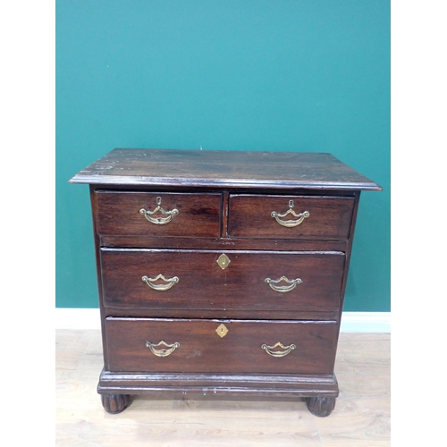 63 - An 18th Century oak Chest with moulded top above two short and two long drawers mounted upon gadroon... 