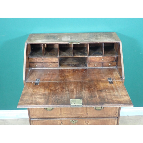 681 - An 18th Century walnut Bureau, the sloping front enclosing a fitted interior above two short and two... 