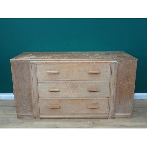 695 - A limed oak art Deco Cabinet with three central drawers flanked by cupboards with side doors and hin... 