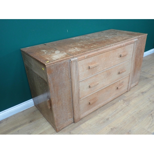 695 - A limed oak art Deco Cabinet with three central drawers flanked by cupboards with side doors and hin... 