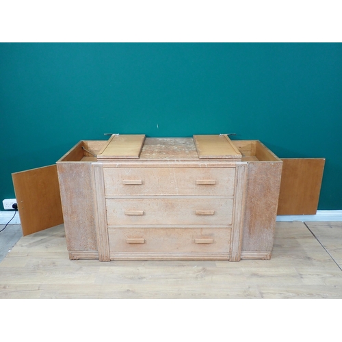 695 - A limed oak art Deco Cabinet with three central drawers flanked by cupboards with side doors and hin... 