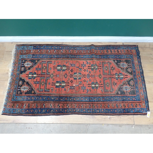 72 - A Persian Rug with blue and red borders, the central ground with stylised motifs on a red ground, 6f... 