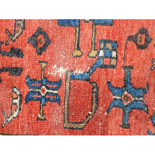 72 - A Persian Rug with blue and red borders, the central ground with stylised motifs on a red ground, 6f... 