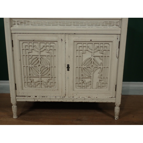 741 - A white painted Whatnot cabinet with raised mirror back and fitted a pair of fret carved panelled do... 