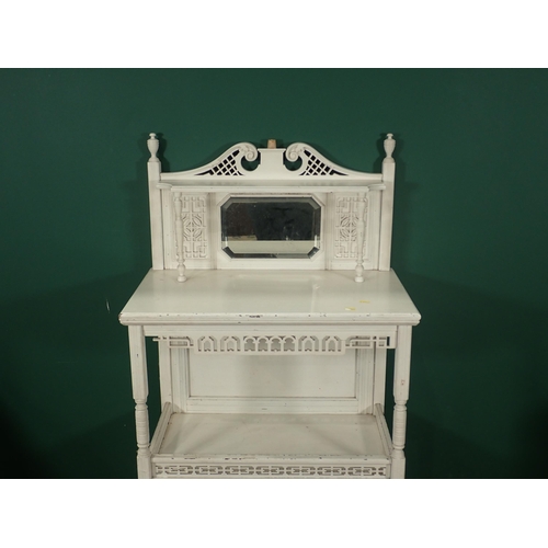 741 - A white painted Whatnot cabinet with raised mirror back and fitted a pair of fret carved panelled do... 