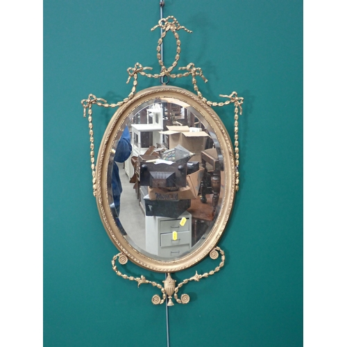 801 - A 19th Century gilt framed oval Wall Mirror with ribbon and urn decoration 2ft 10in x 1ft 7in