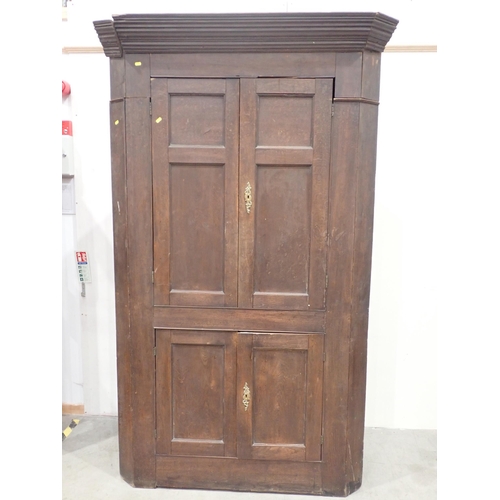 819 - An antique oak standing Corner Cupboard fitted two pairs of panelled doors 7ft 1in H x 4ft 6in W