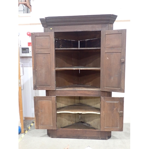 819 - An antique oak standing Corner Cupboard fitted two pairs of panelled doors 7ft 1in H x 4ft 6in W