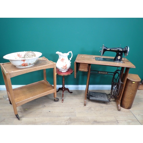 82 - A Singer Sewing Machine on stand, an oak Tea Trolley and a Wash Jug and Bowl