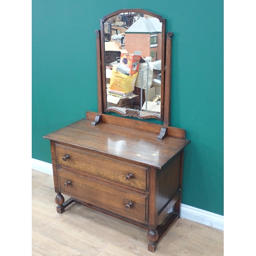 90 - An oak Chest of four drawers and a Dressing Chest fitted two drawers