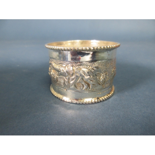 94 - One dozen Indian sterling silver Napkin Rings embossed elephants, etc, and two Indian Dishes, leafag... 