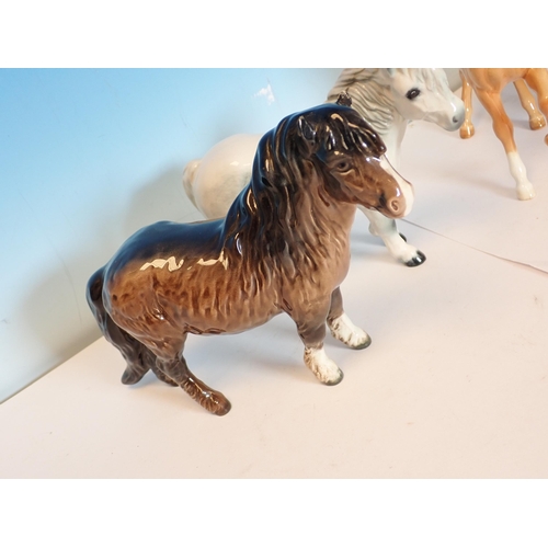 599 - Two Beswick palomino Horses and a Foal, two Beswick Welsh Ponies and a bay Foal