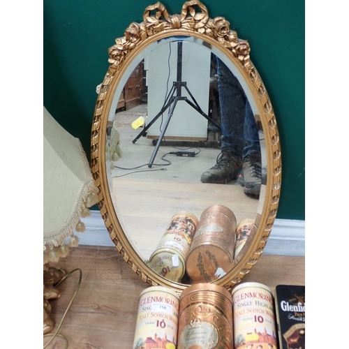 758 - A gilt framed oval Wall Mirror, gilded Table Lamp and Shade (failed PAT) and four Whisky Bottle Tins