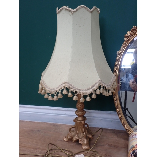 758 - A gilt framed oval Wall Mirror, gilded Table Lamp and Shade (failed PAT) and four Whisky Bottle Tins