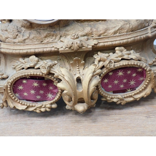 763 - A 19th Century gilded metal Mantel Clock with shooting man and hanging game surmount