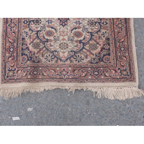 652 - A bordered Runner with oval medallions on a cream ground, 10ft 1in x 2ft 7in