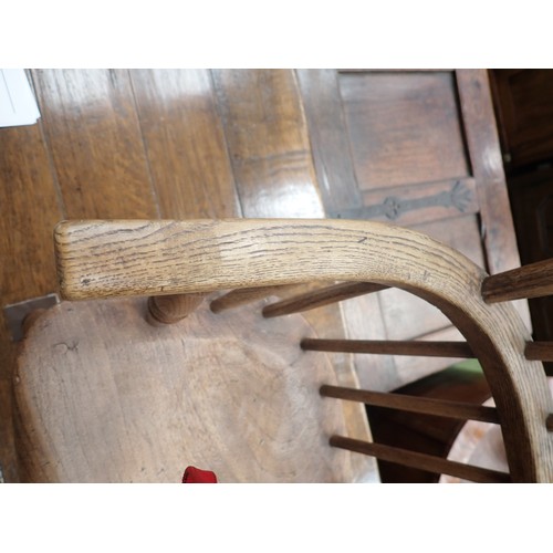 66 - A 19th Century ash and elm child's Windsor Elbow Chair with hoop back on turned supports and stretch... 