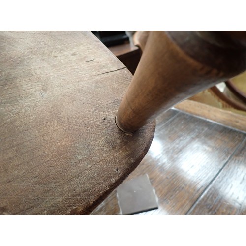 66 - A 19th Century ash and elm child's Windsor Elbow Chair with hoop back on turned supports and stretch... 