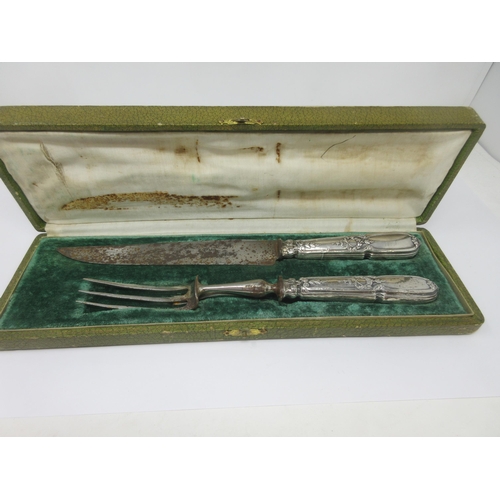 100A - A French silver handled Carving Knife and a three prong Fork, in case