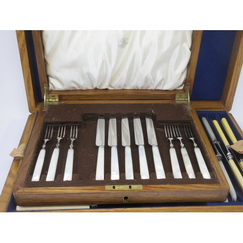 118 - An oak Case containing tray of Knives and Carvers, and a case of six Dessert Knives and Forks