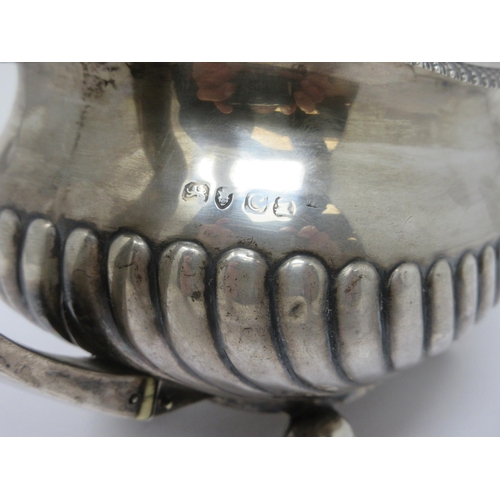 119 - A George III silver boat-shape Teapot with gadroon embossing, leafage handle and spout, flower finia... 