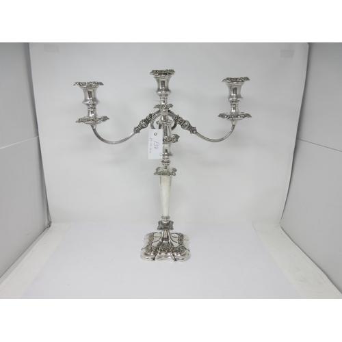 138 - A pair of plated Candlesticks with leafage columns, and a similar two-branch Candle Holder, repaired