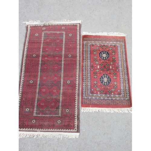 15 - A bordered Afghan Rug with oblong field, cream latch hook border, 5ft 8in x 2ft 8in, and a small mod... 