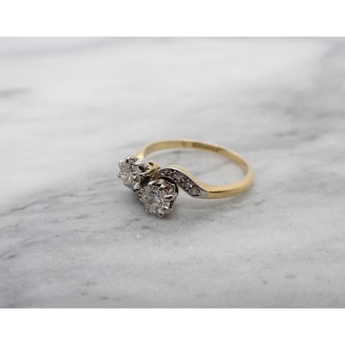 173 - A Diamond two stone crossover Ring claw-set old-cut stones with eight-cut stones pavé-set to shoulde... 