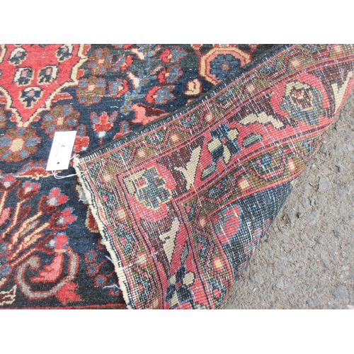 2 - An old bordered Ferahagn Rug with floral and palmette design in red on a dark blue ground, 6ft 6in x... 