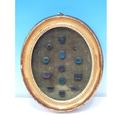 216 - A collection of thirteen Intaglio Seals mounted in gilt frame