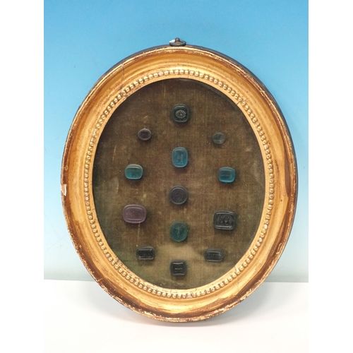 216 - A collection of thirteen Intaglio Seals mounted in gilt frame