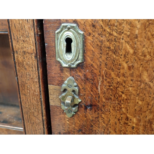 23 - A George III oak and mahogany crossbanded Dresser and rack the base fitted three drawers above shape... 