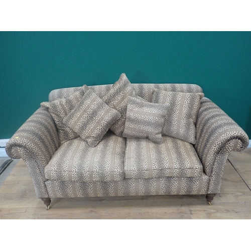 254 - A two seater Sofa on turned mahogany supports with leopard print upholstery