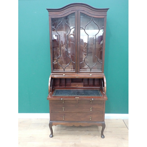 27 - An Edwardian mahogany and inlaid Bureau Bookcase fitted pair of glazed doors above roll top base fit... 